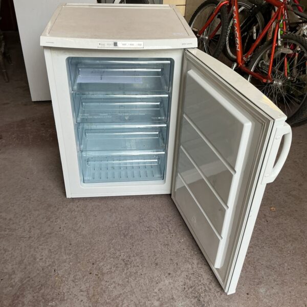 White John Lewis chest freezer open, showing interior storage baskets.