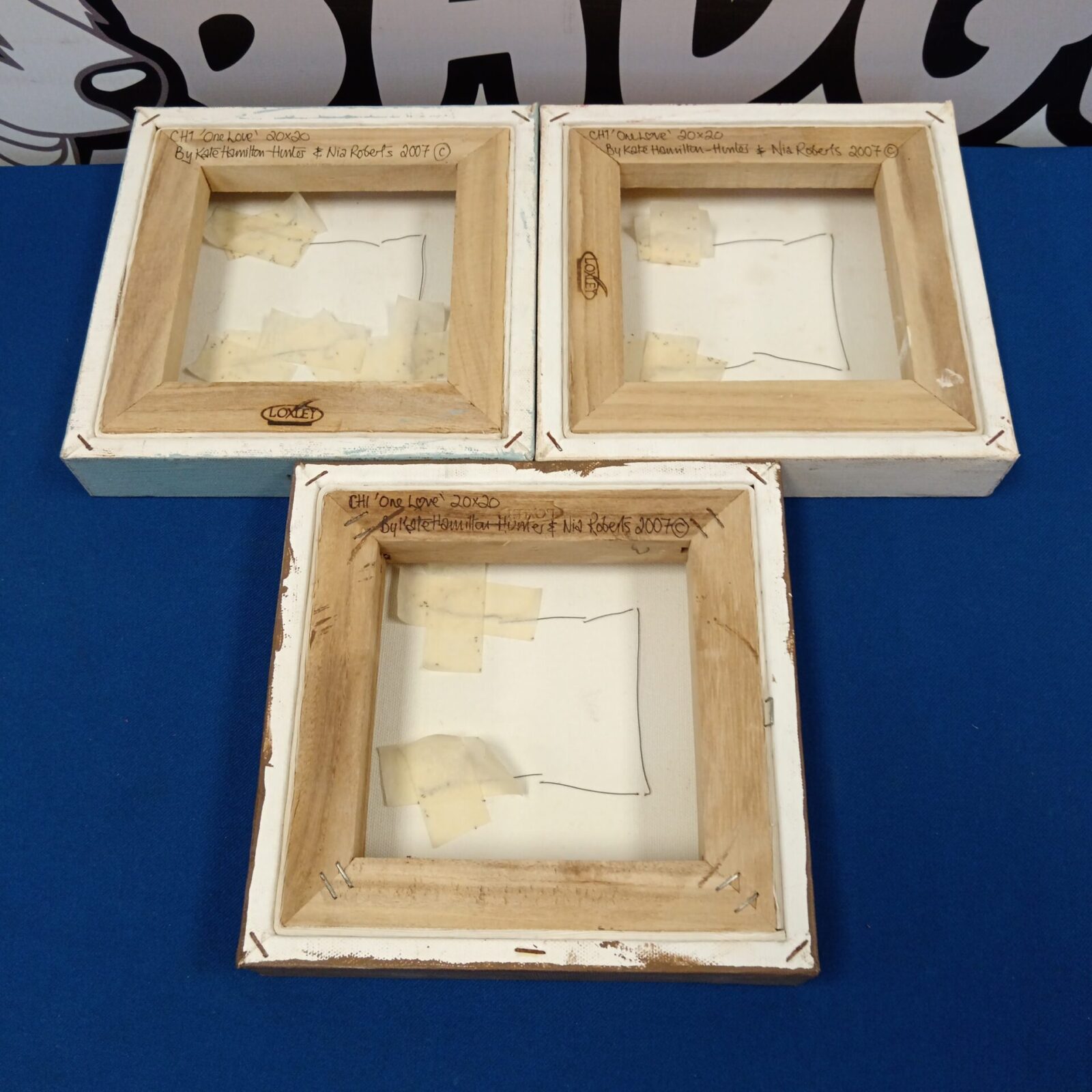 Set of three Kate Hamilton heart canvas artworks displayed together.