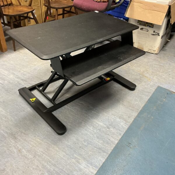 Black Kensington desk converter for adjustable standing workstation.