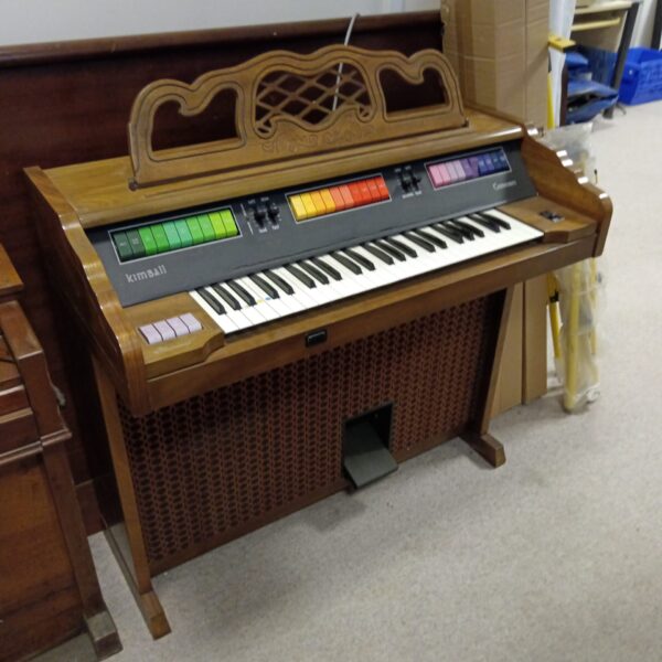 Front view of a vintage Kimball Caravan electric organ.