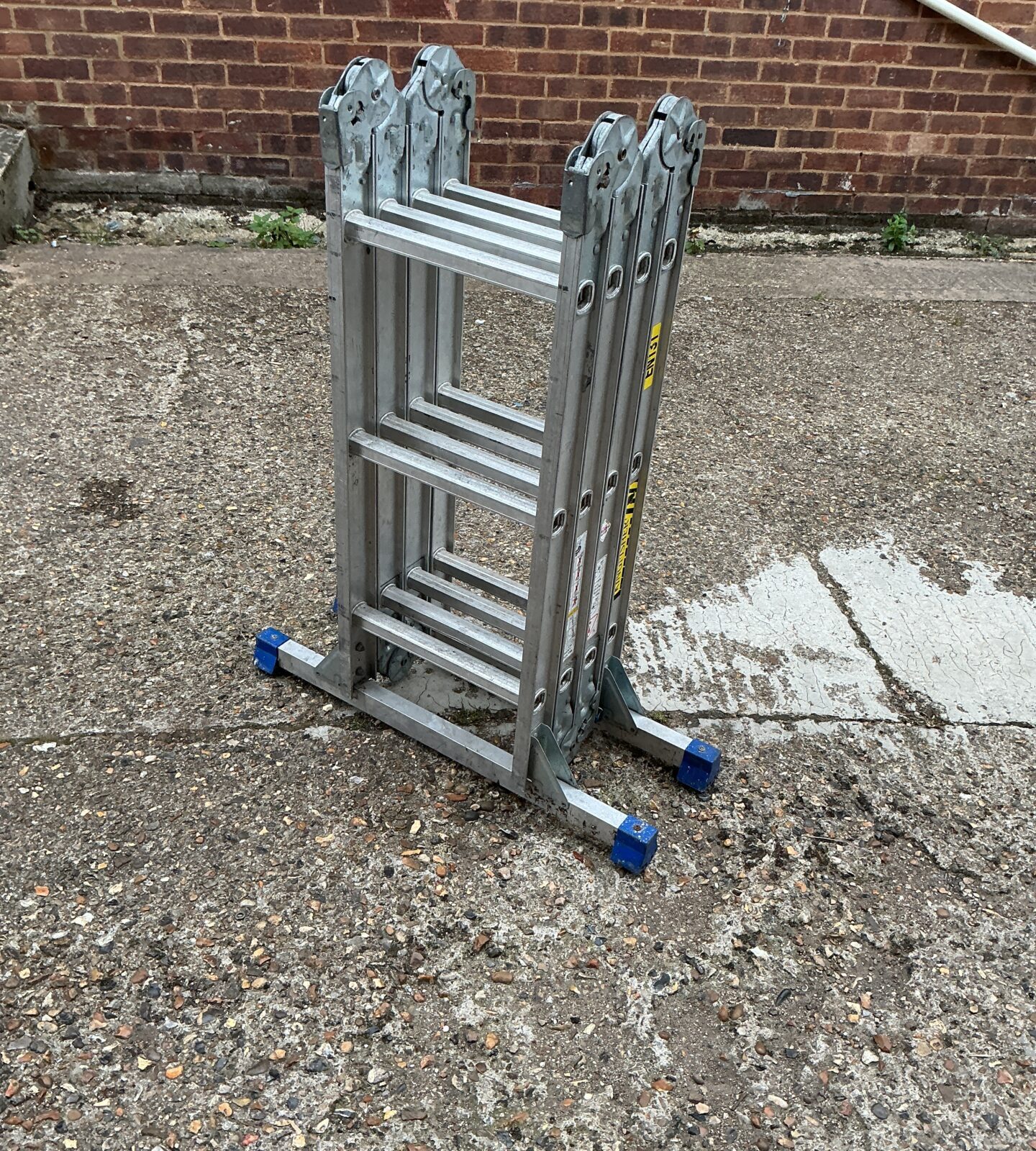 Silver Kingfisher multi-purpose aluminium ladder in a garden setting.