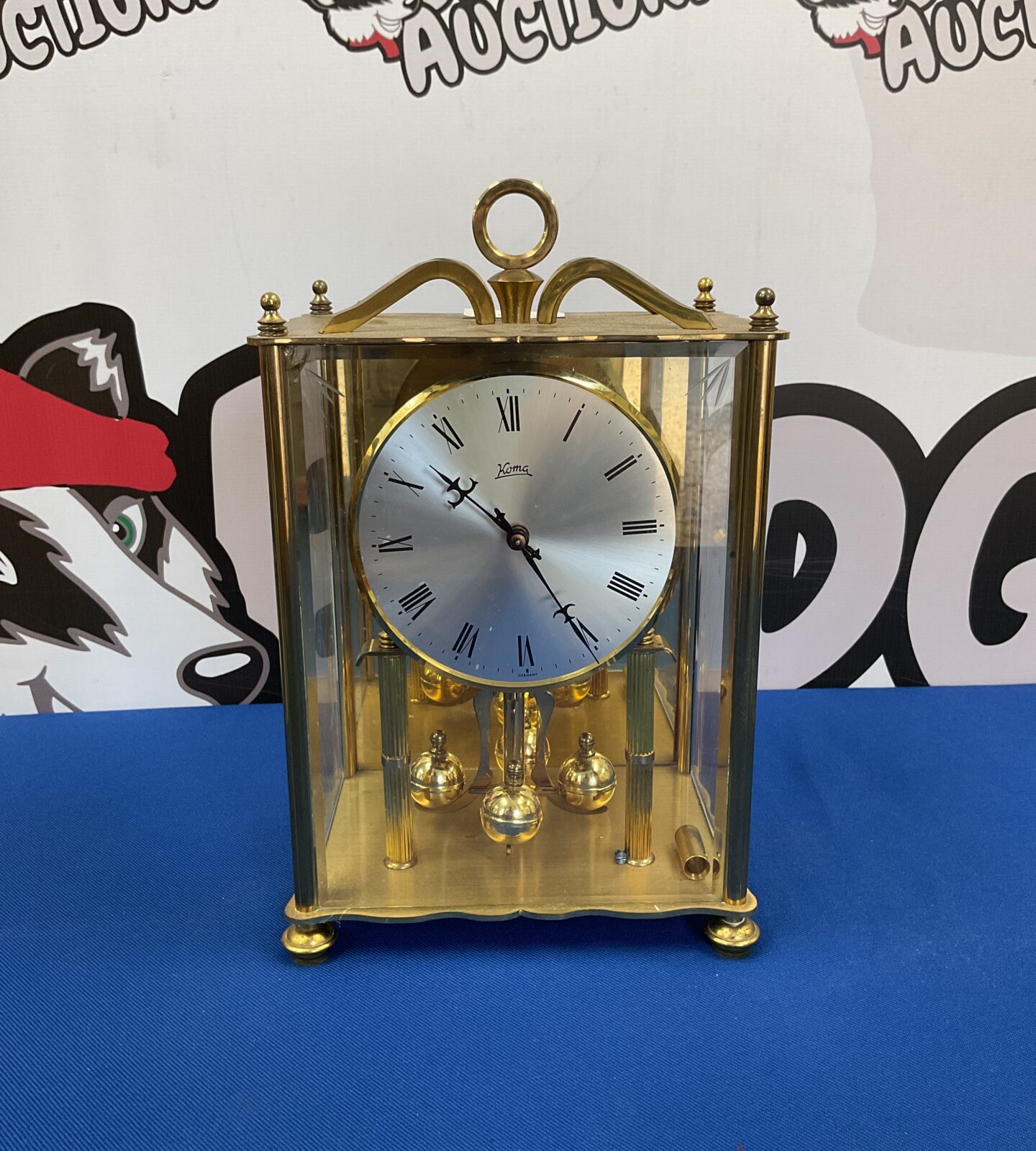 Vintage brass Koma anniversary clock on display.