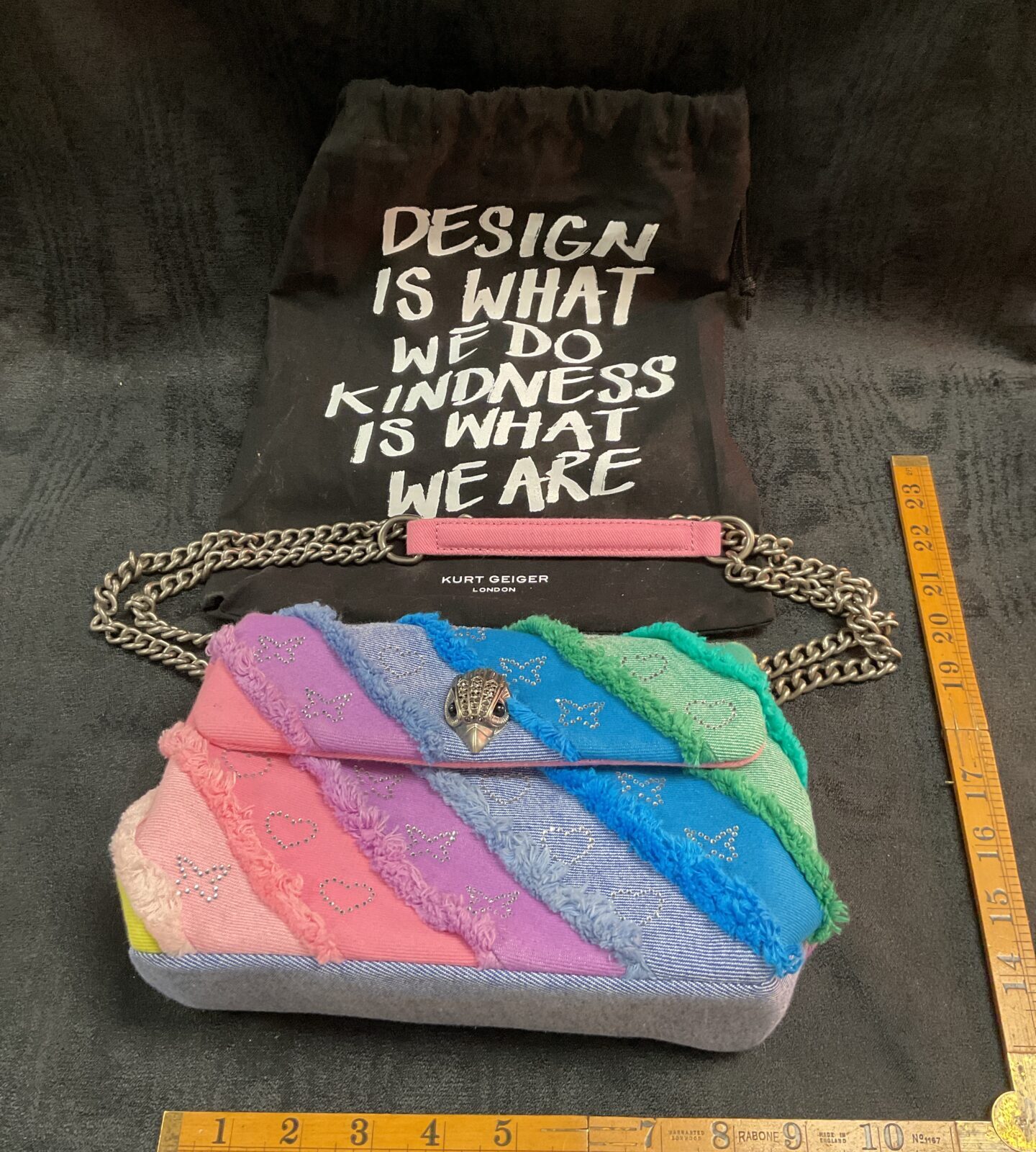 Vibrant Kurt Geiger rainbow handbag, colourful designer fashion accessory.