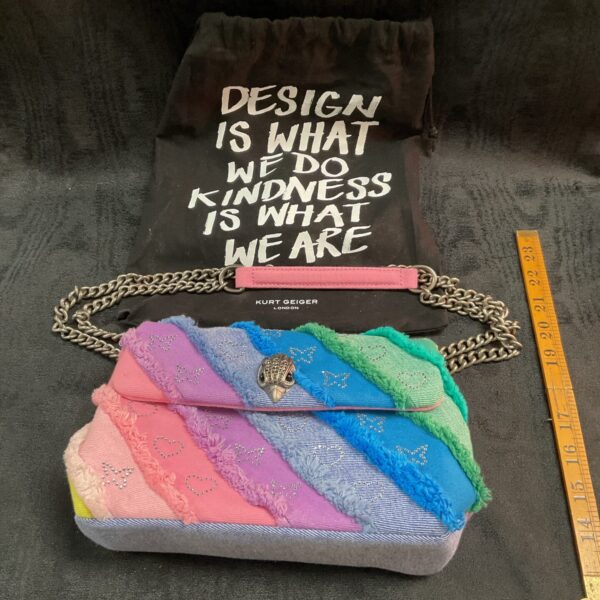 Vibrant Kurt Geiger rainbow handbag, colourful designer fashion accessory.