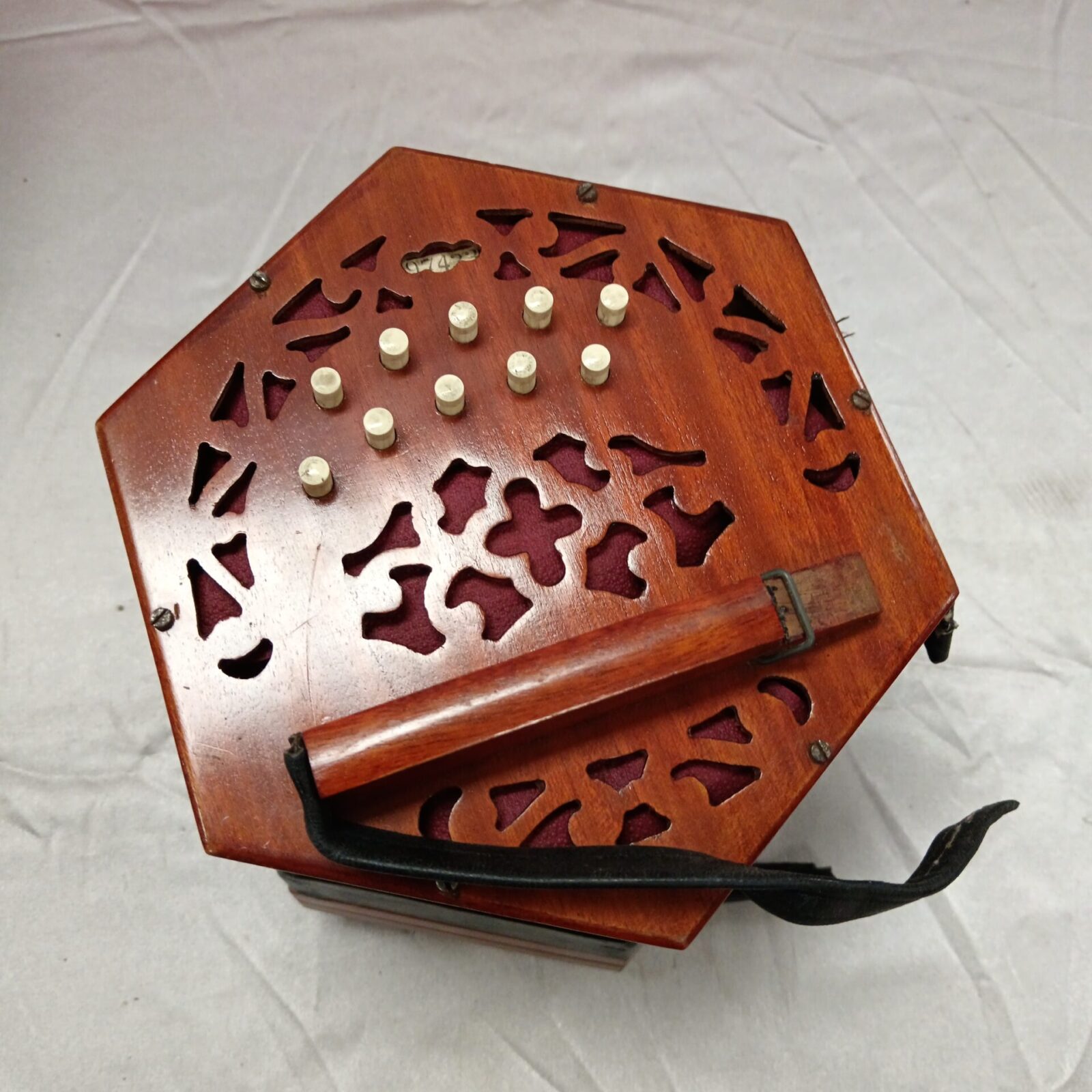 Detailed view of fretwork on antique Lachenal concertina.