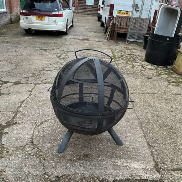 Steel Lanmann metal fire pit in a garden setting.
