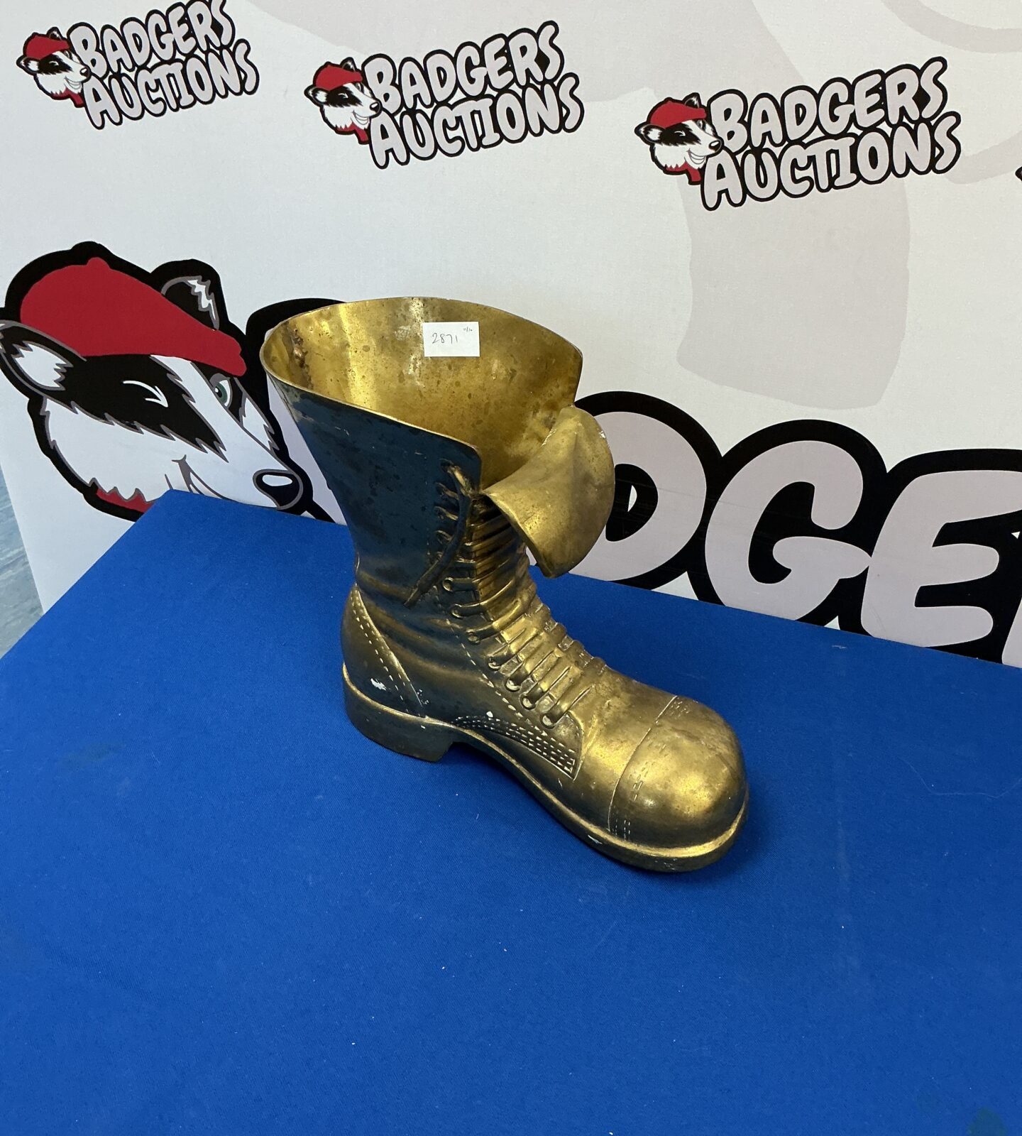 Large brass boot sculpture, vintage decorative item.