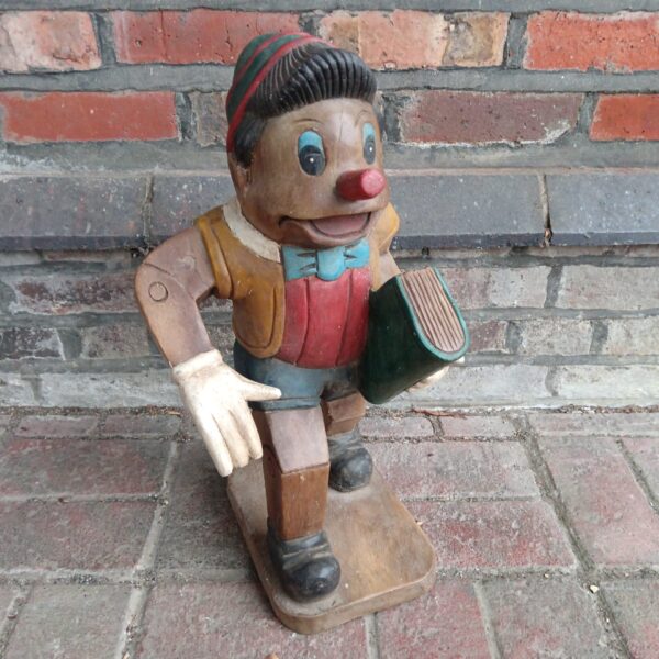 Vintage hand-carved wooden Pinocchio statue, colourful folk art collectible.