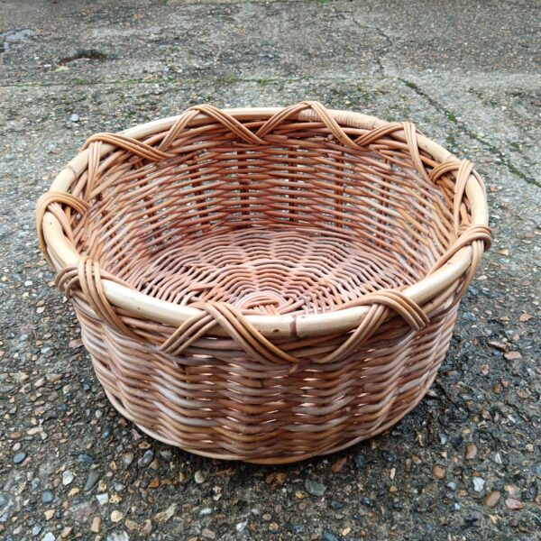 Large wicker log basket for firewood storage, rustic style.