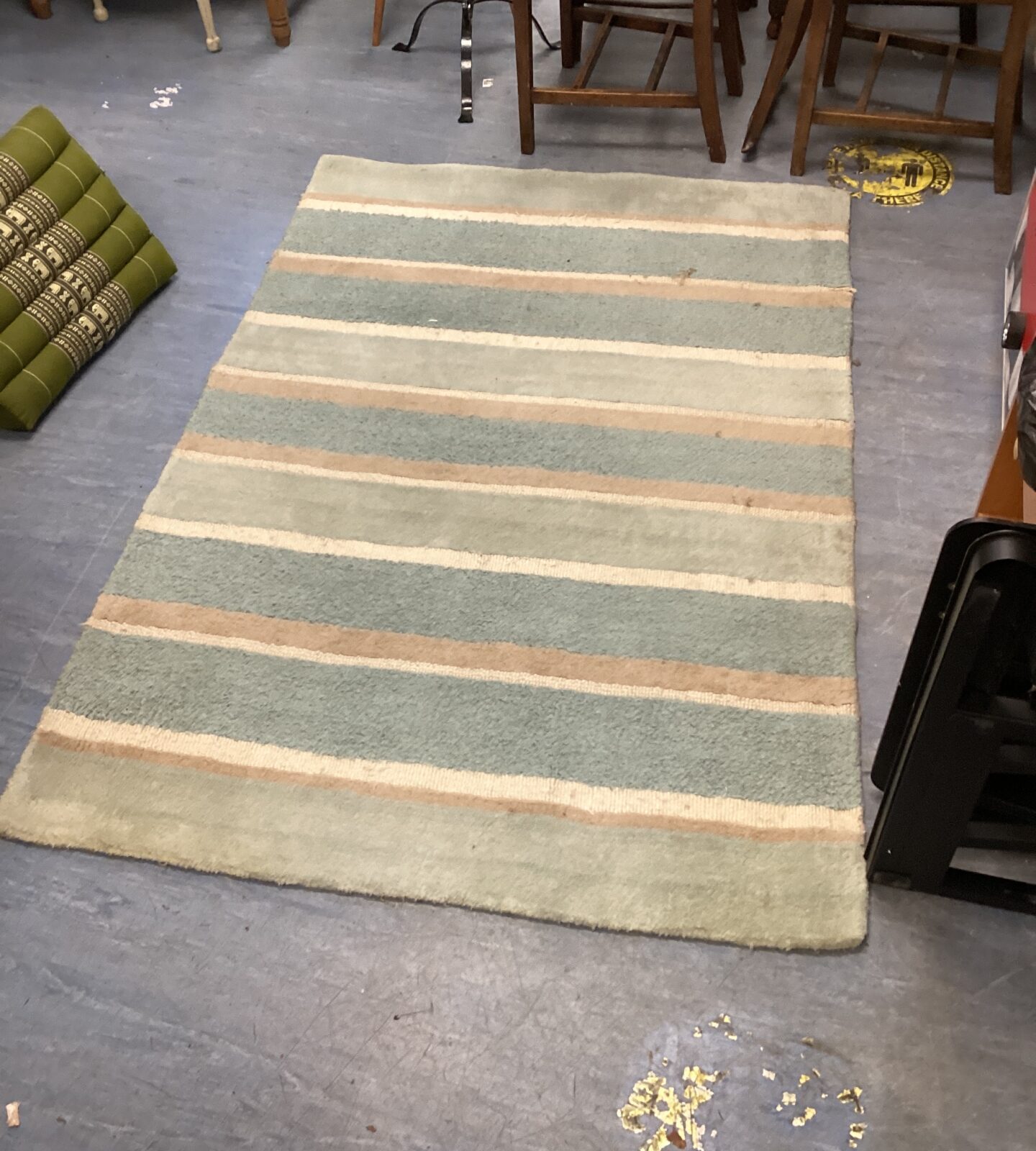 Blue, brown, and cream striped Laura Ashley rug on a floor.