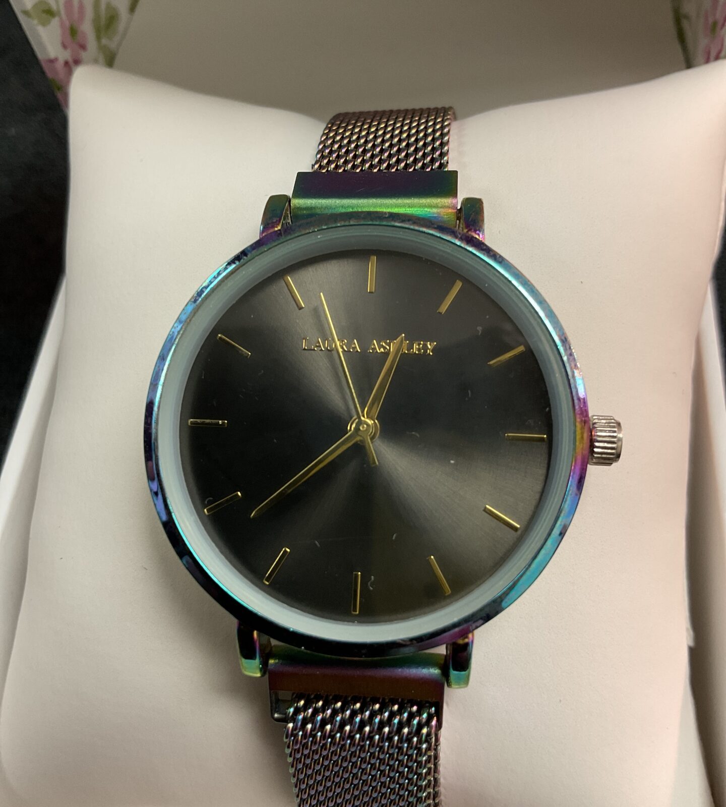 Front view of a Laura Ashley iridescent mesh strap wristwatch.
