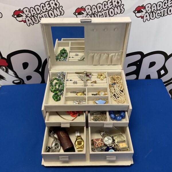 Vintage leather jewellery box filled with silver and assorted jewellery.