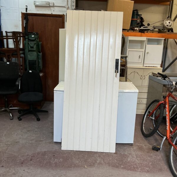 Vintage ledge and brace door in salvaged condition.