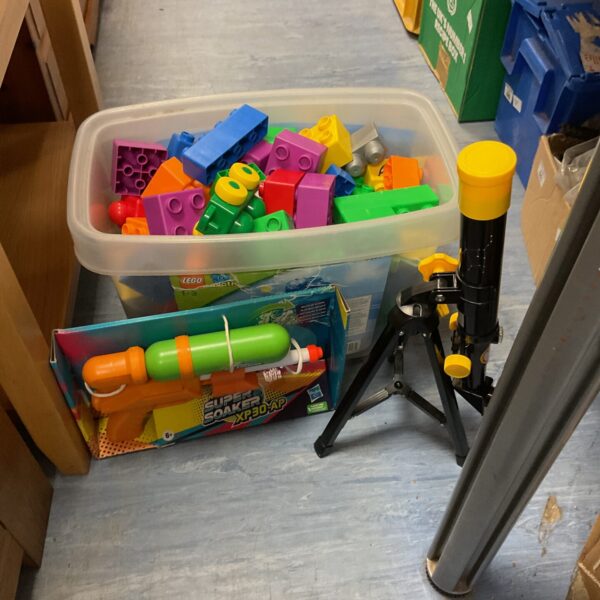 Lego Duplo blocks with Nerf Super Soaker and telescope in a toy bundle.