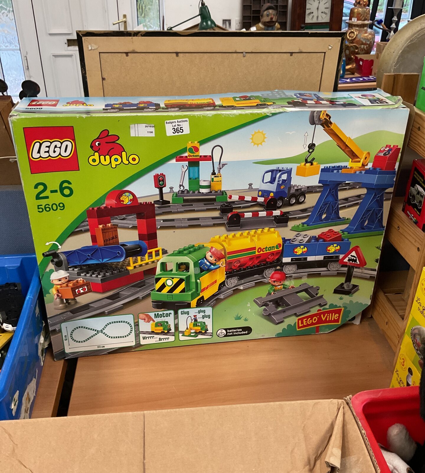 Colourful Lego Duplo train set 5609 with railway and figures.