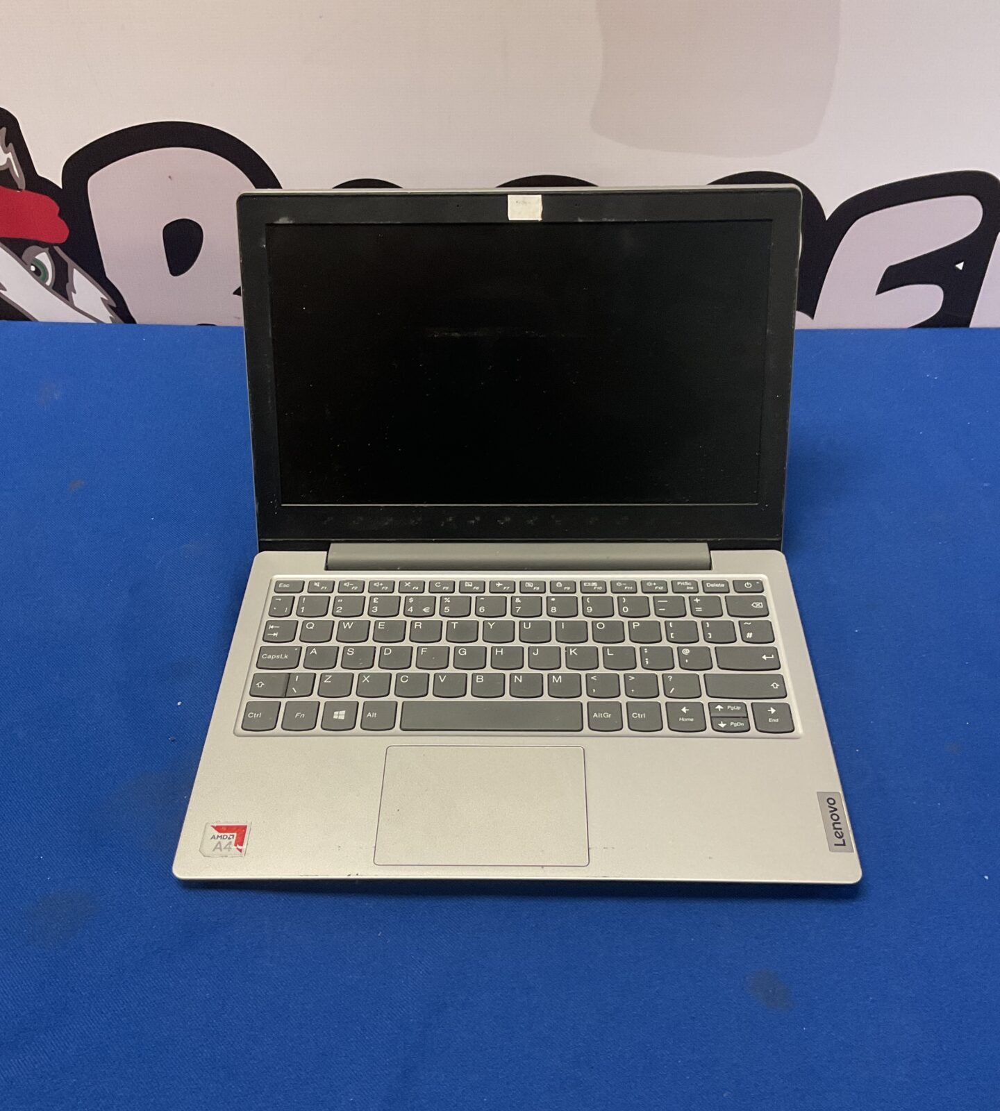 Silver Lenovo IdeaPad Slim laptop with keyboard visible.