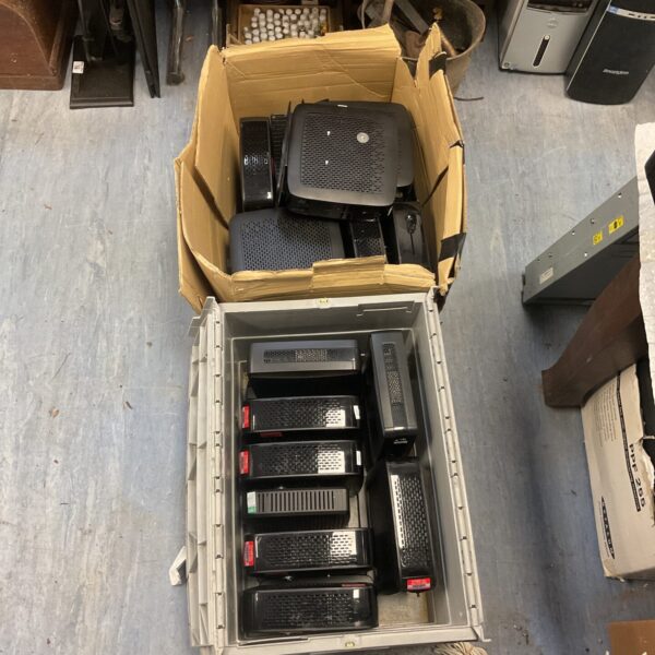 Lot of Ligel thin client computers in cardboard boxes.