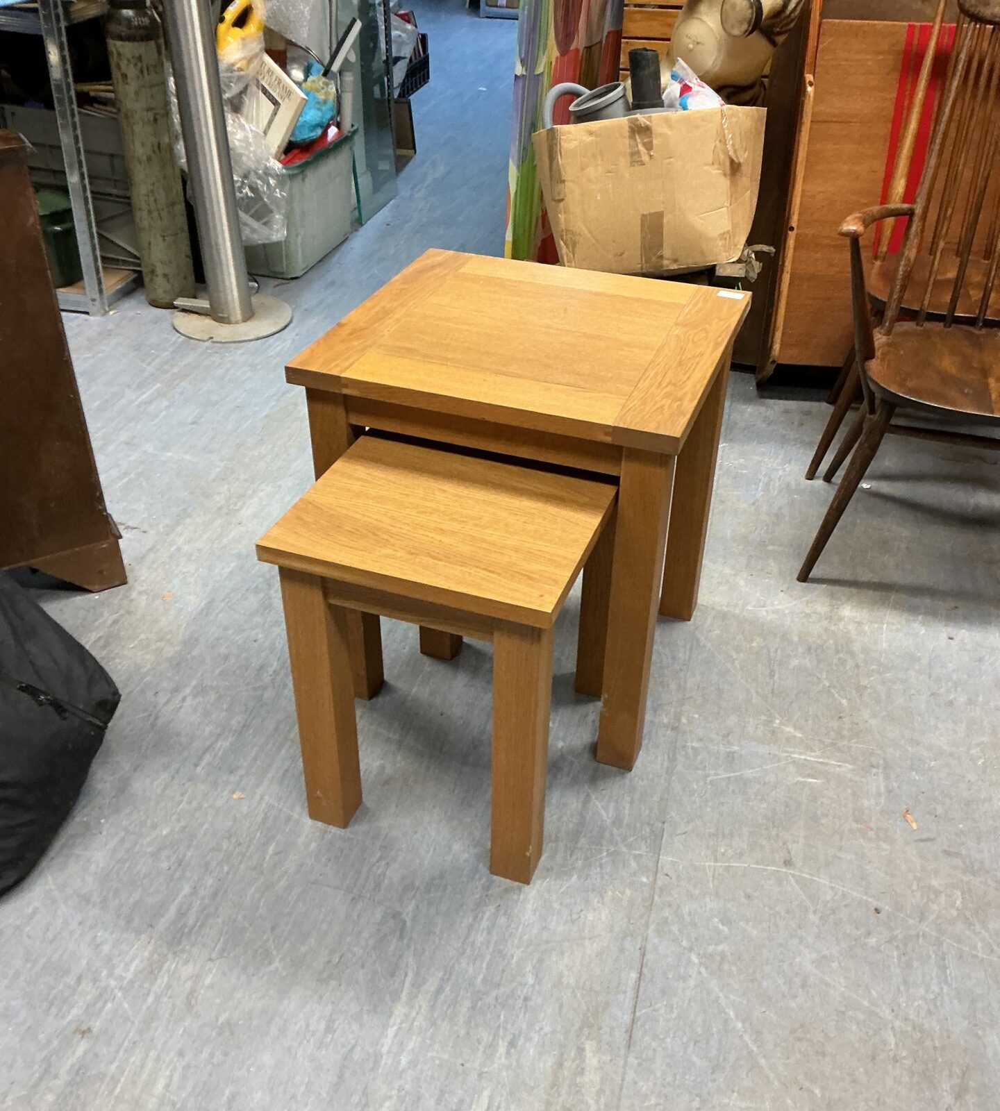 Pair of light oak nesting occasional tables in a home setting.