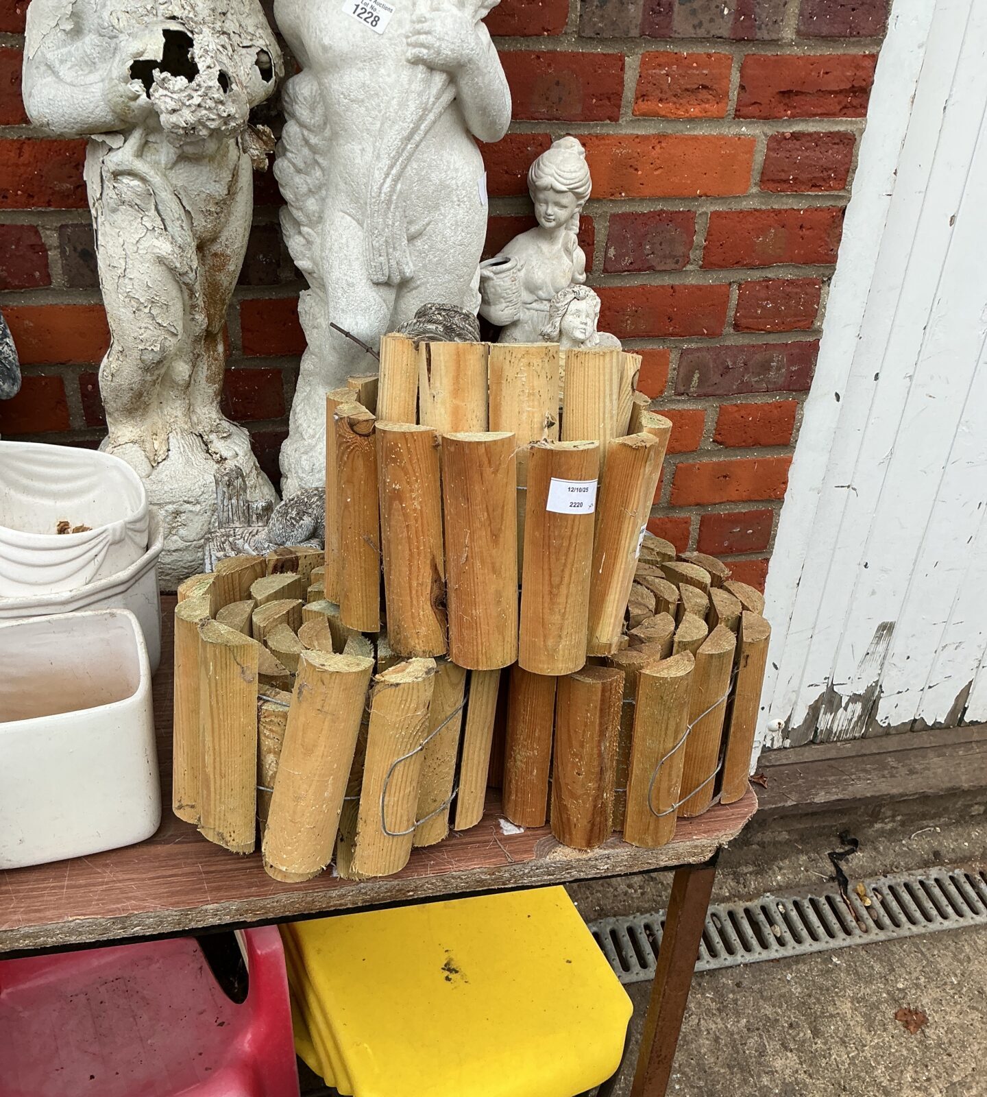 Three rolls of rustic log garden edging for landscaping.