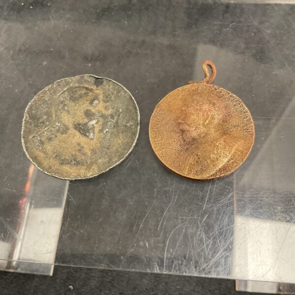 Antique London bronze attendance medal with intricate detailing.