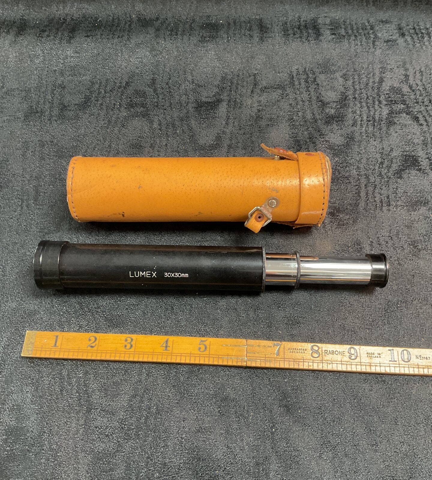 Vintage Lumex pocket telescope with leather case.