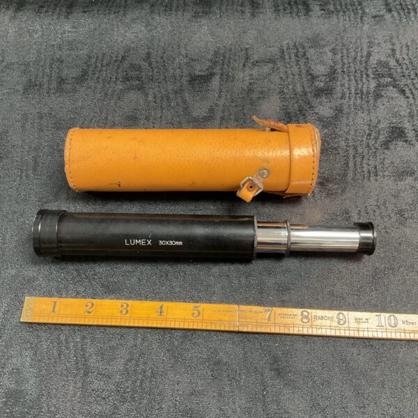 Vintage Lumex pocket telescope with leather case.