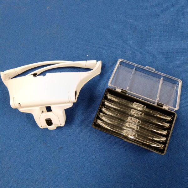 Vintage magnifying visor with interchangeable lenses for detailed work.