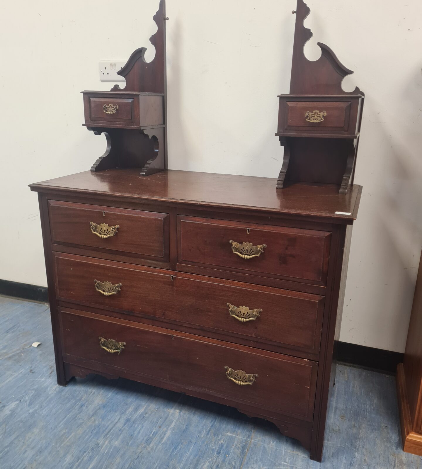 Antique mahogany dressing table with brass handles and drawers.