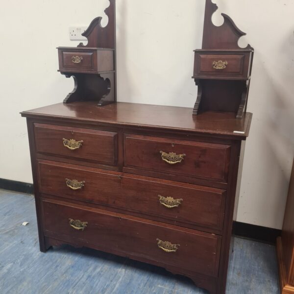 Antique mahogany dressing table with brass handles and drawers.