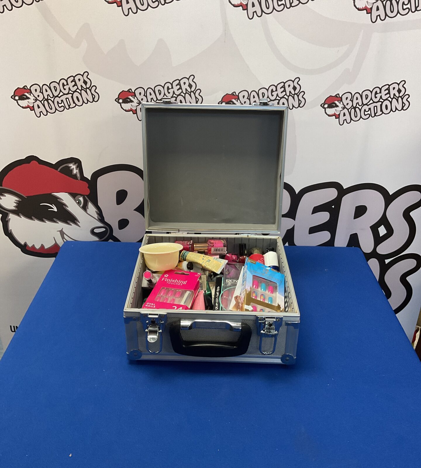 Black makeup case filled with a mixed lot of beauty products.