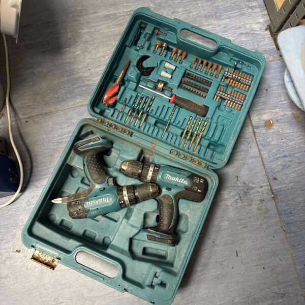 Makita cordless drill kit with accessories in open case.