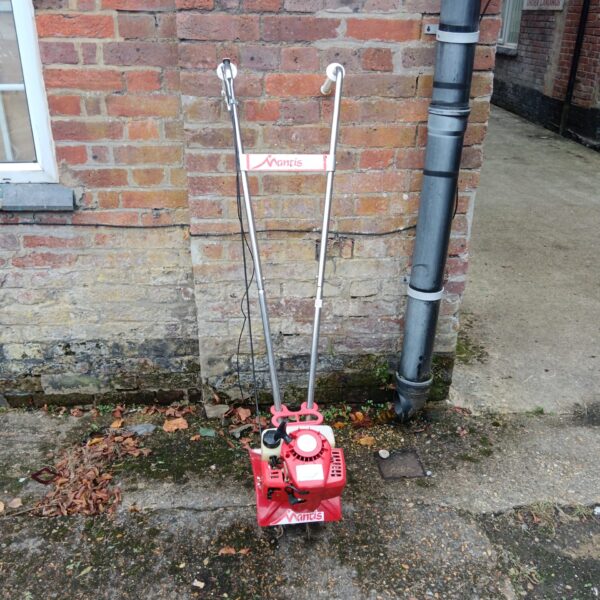 Red Mantis petrol rotavator for garden soil cultivation.