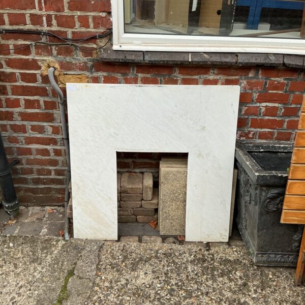 Vintage marble effect fire surround for a classic fireplace.