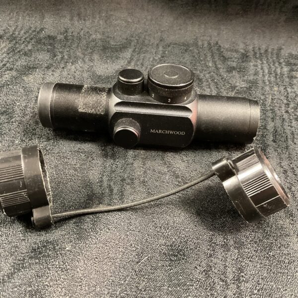 Front view of a Marchwood red dot sight with protective covers.