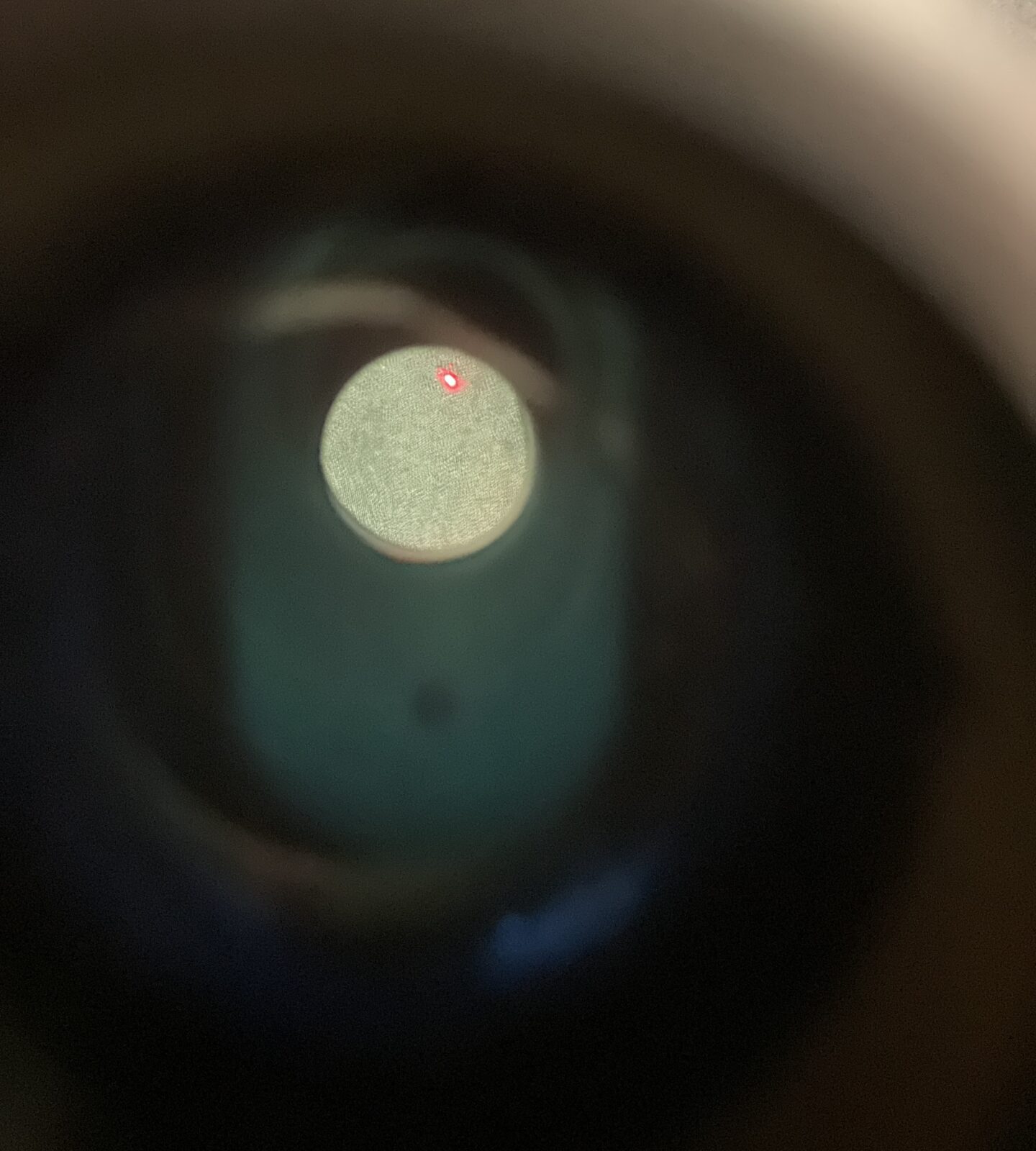 Side view of a Marchwood red dot sight with adjustment knobs visible.