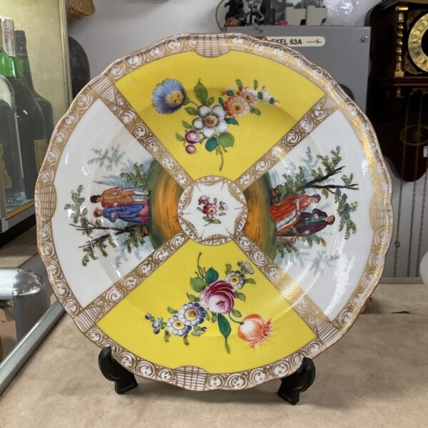 Antique Meissen porcelain plate with floral design and gilded rim.