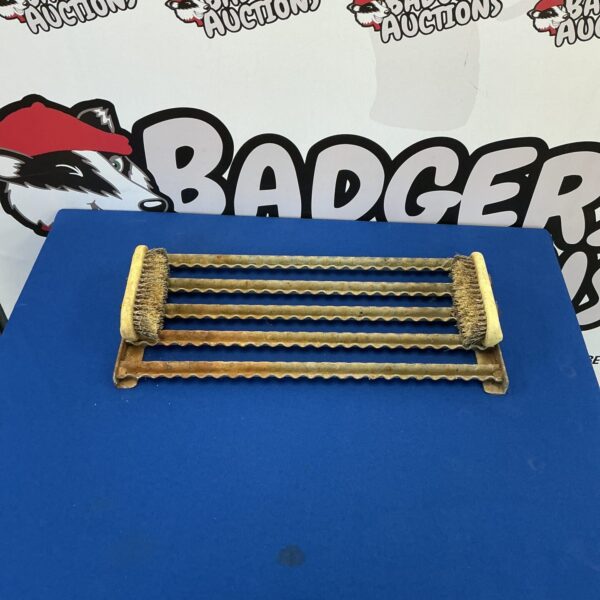 Vintage metal boot scraper with metal bristles for cleaning footwear.