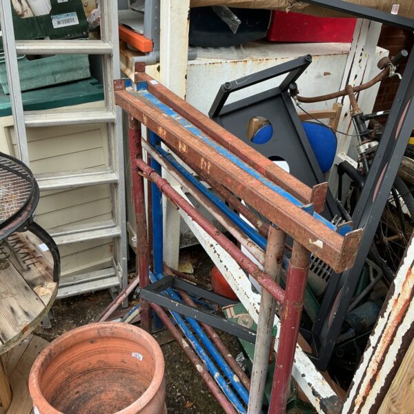 Vintage metal builder’s trestles for workshop or construction use.