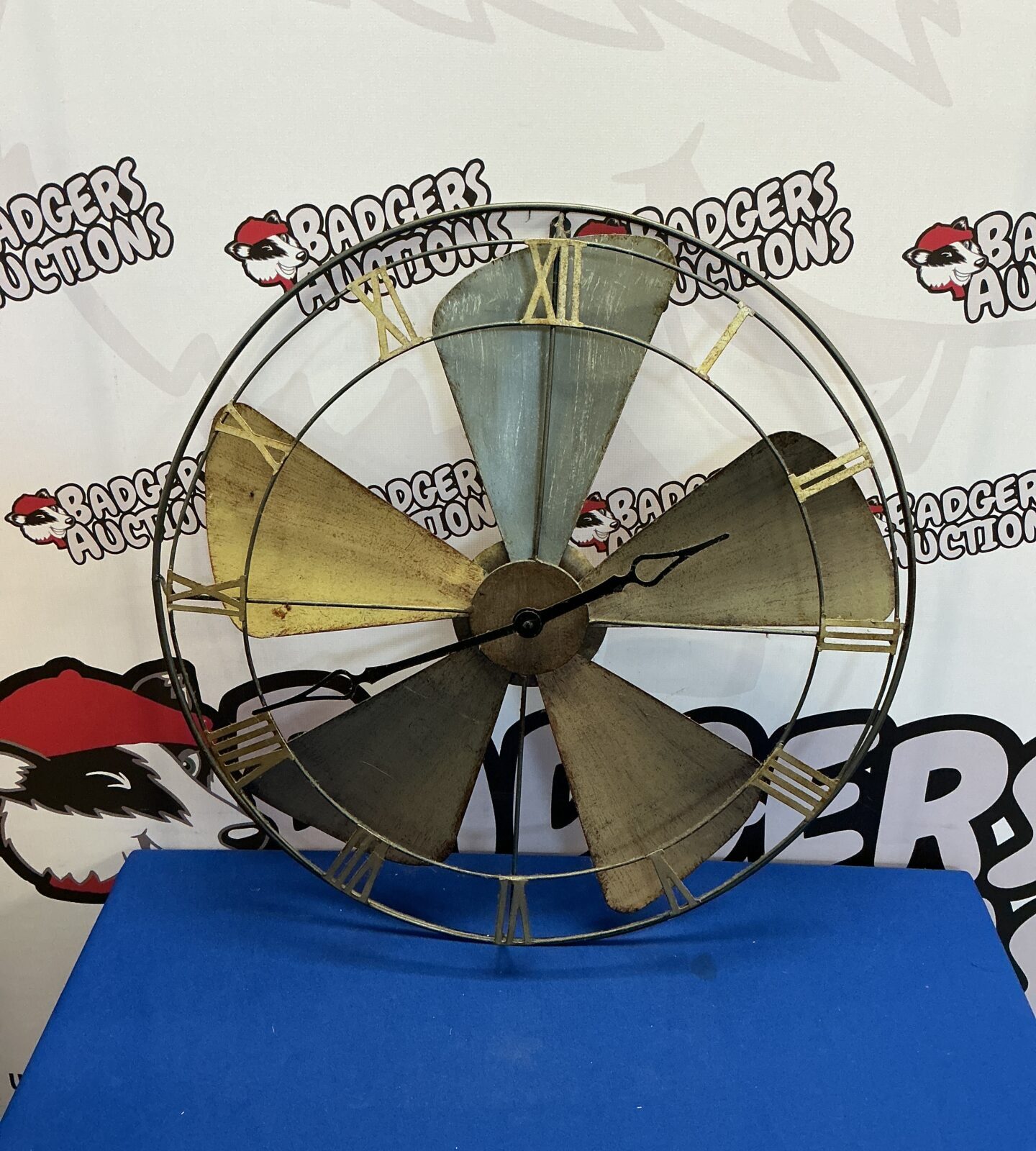 Vintage metal fan wall clock for industrial farmhouse decor.