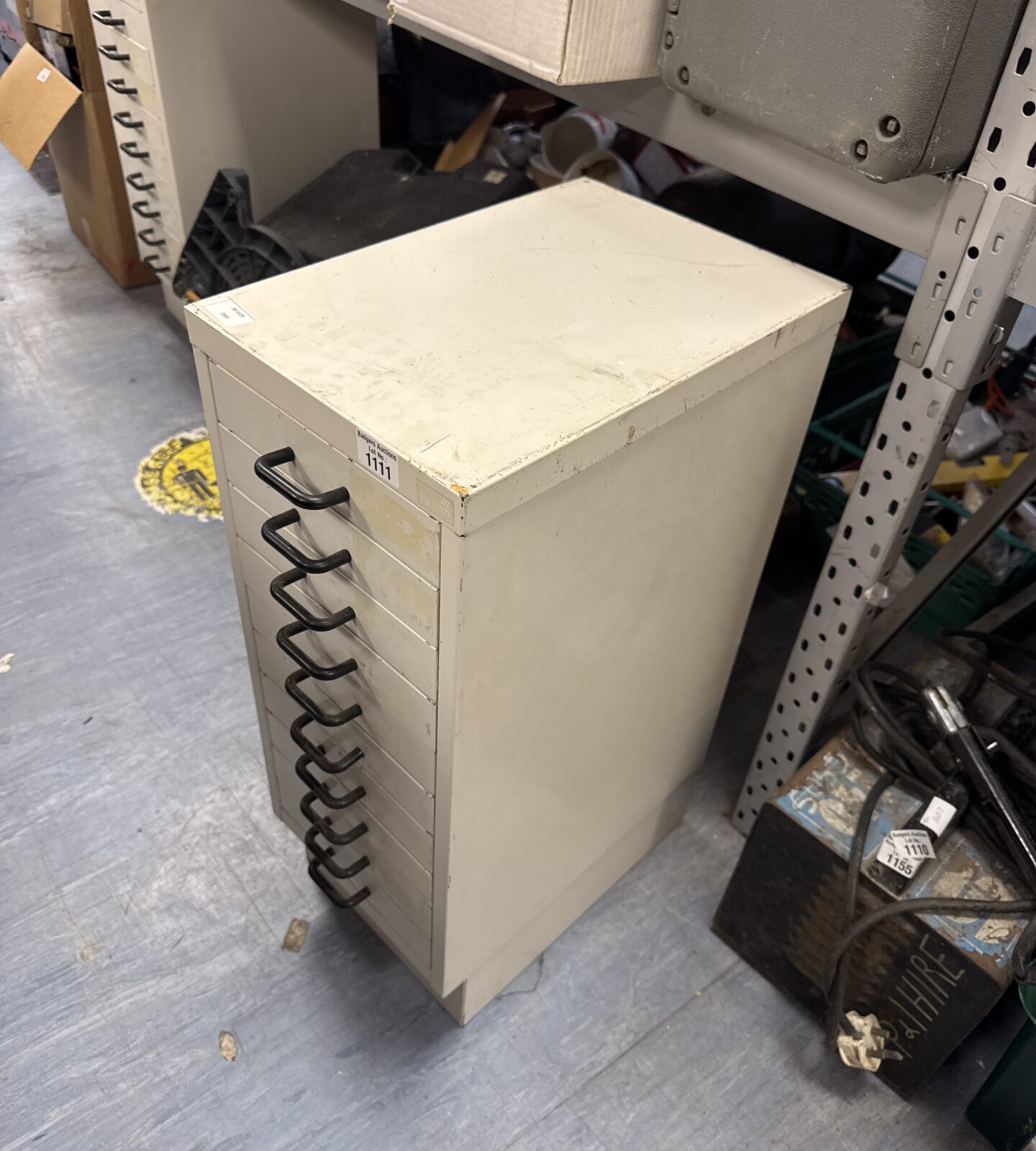 Front view of a vintage metal filing cabinet for office storage.
