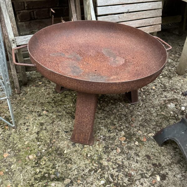 Rustic metal fire pit for garden or patio use.