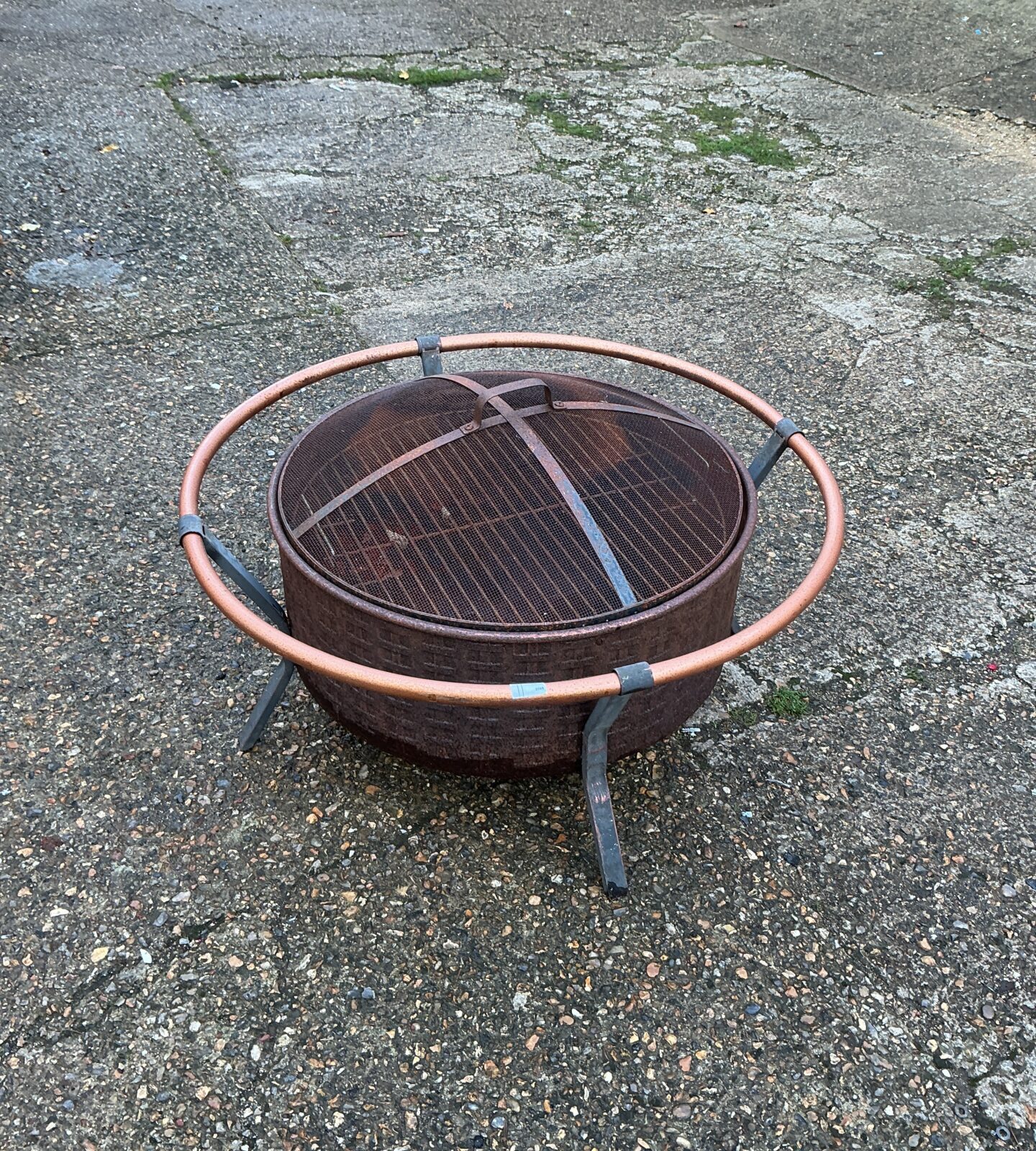 Rustic metal fire pit for garden or patio use.