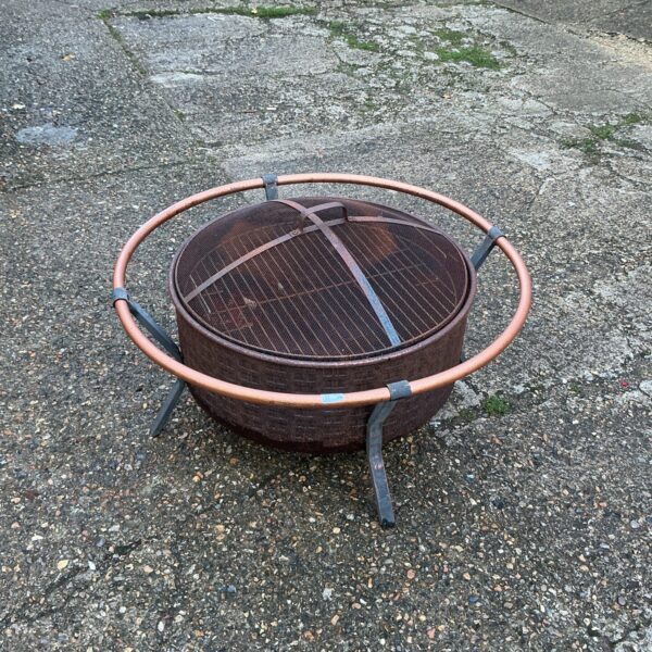 Rustic metal fire pit for garden or patio use.