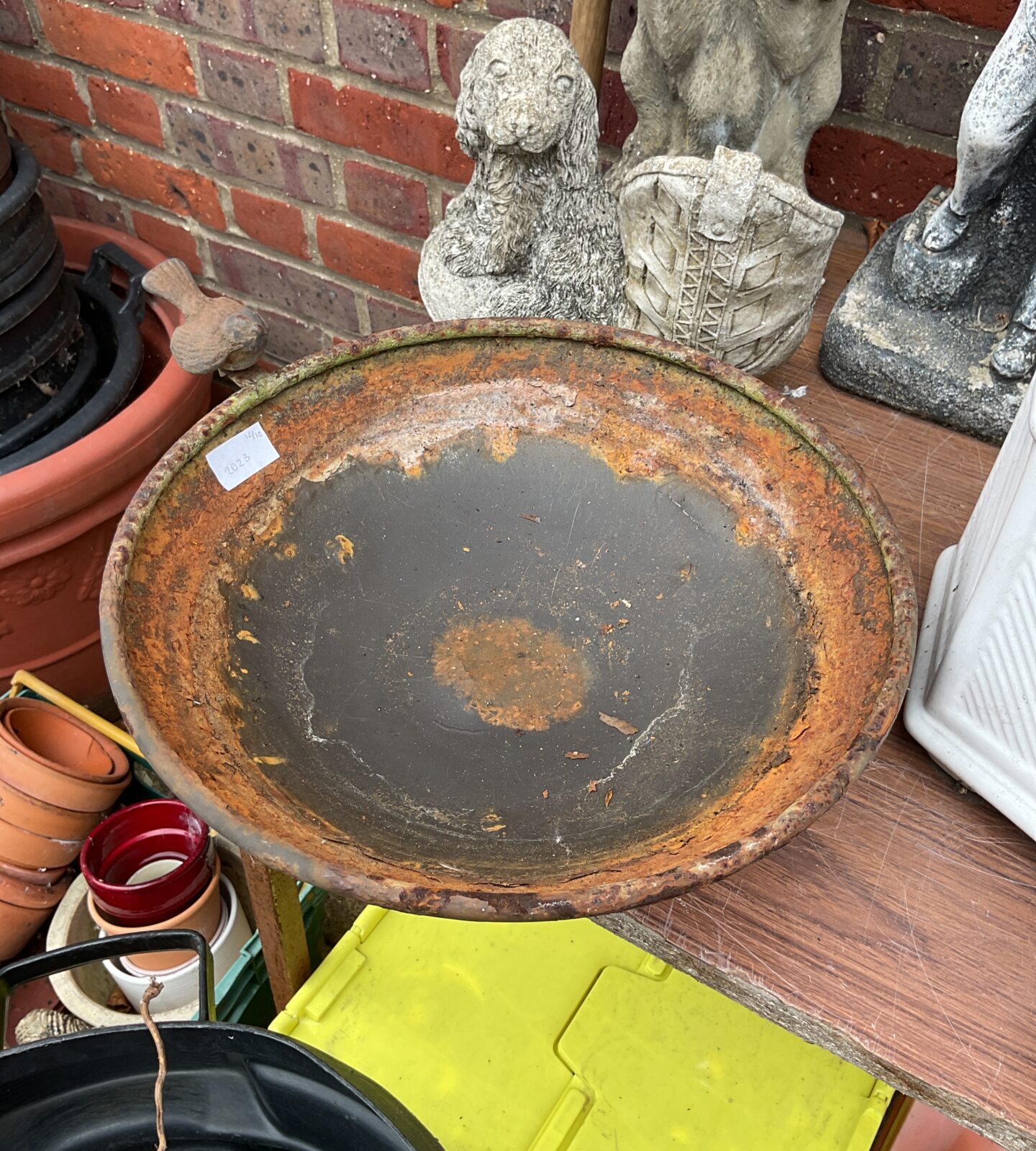 Vintage metal garden bird bath, weathered patina, outdoor garden feature.