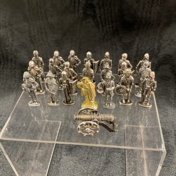Metal soldier collection with miniature cannon on display.