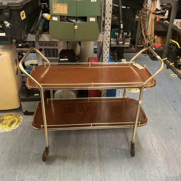 Vintage mid-century teak cocktail trolley with tiered shelving.