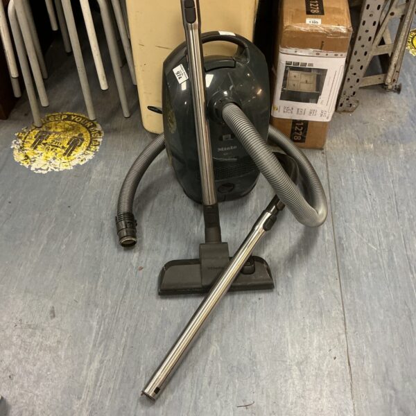 Vintage Miele S2 cylinder vacuum cleaner for home cleaning.