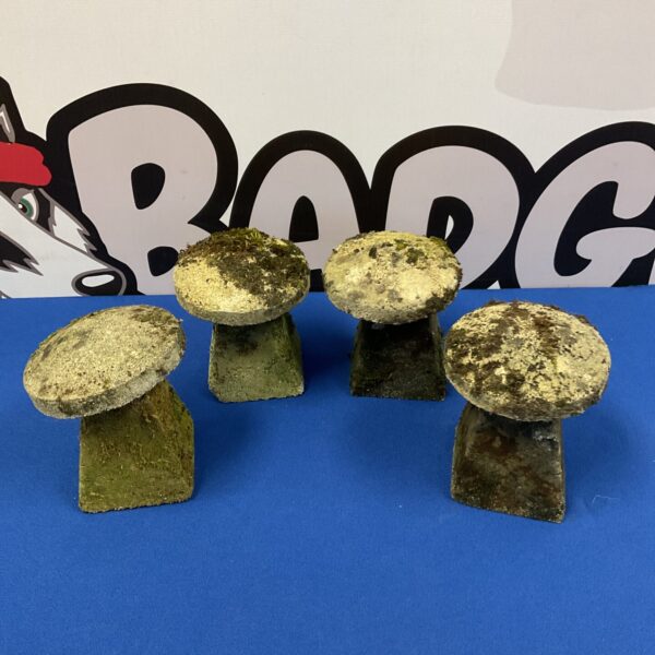 Set of four miniature stone staddle stones for garden display.
