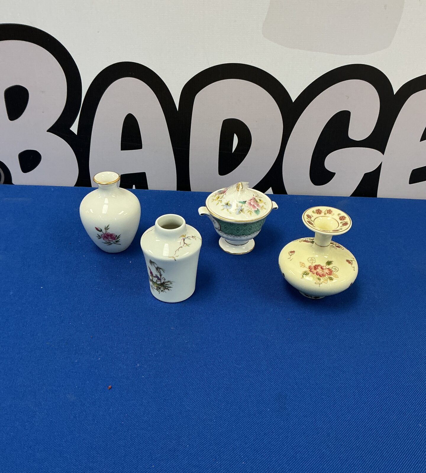 Collection of four miniature porcelain vases, including Limoges and Royal Doulton.