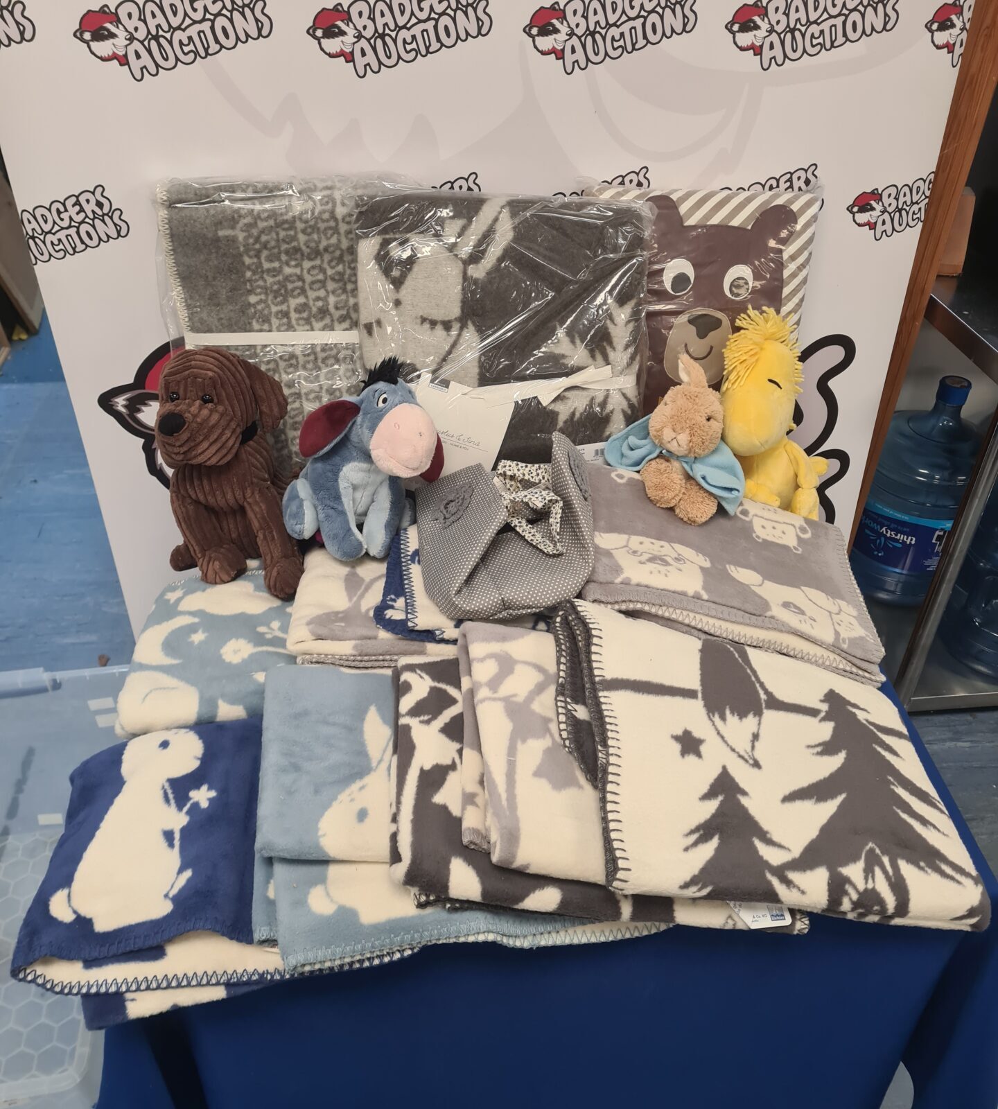 Mixed lot of blankets and soft toys including Disney characters.